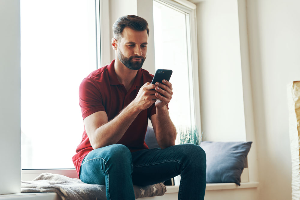 Female using phone on bed